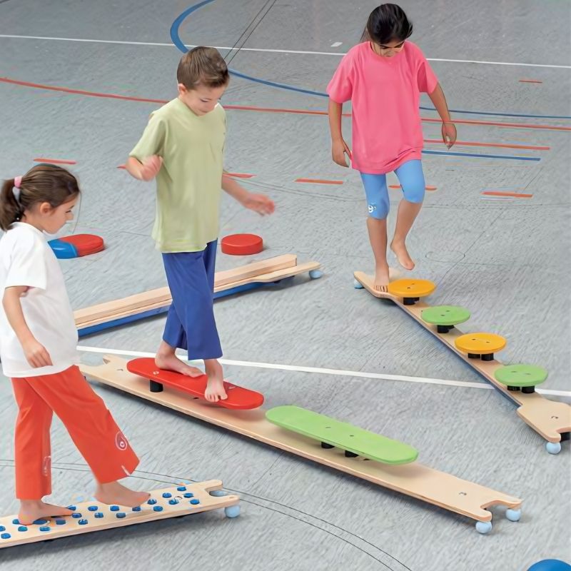 Children navigating the HABA Pro 5 Balancing Board Set, developing gross motor skills and balance coordination through active play