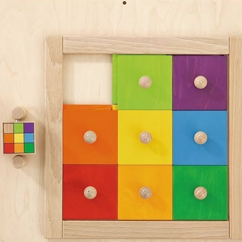 HABA Pro Colorful Squares Sensory Wall panel front view showing eight sliding coloured wood squares and rotating pattern cube