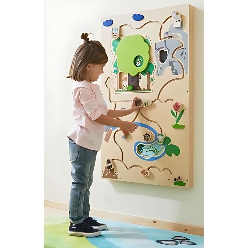 Child engaging with the HABA Pro Forest Sensory Wall Panel, sliding grass elements to reveal hidden creatures during active tactile play