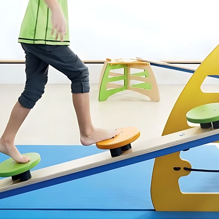 Close-up of HABA Pro Monkey Ladder balancing board with fifteen wooden shapes, supporting foot coordination and tactile discrimination