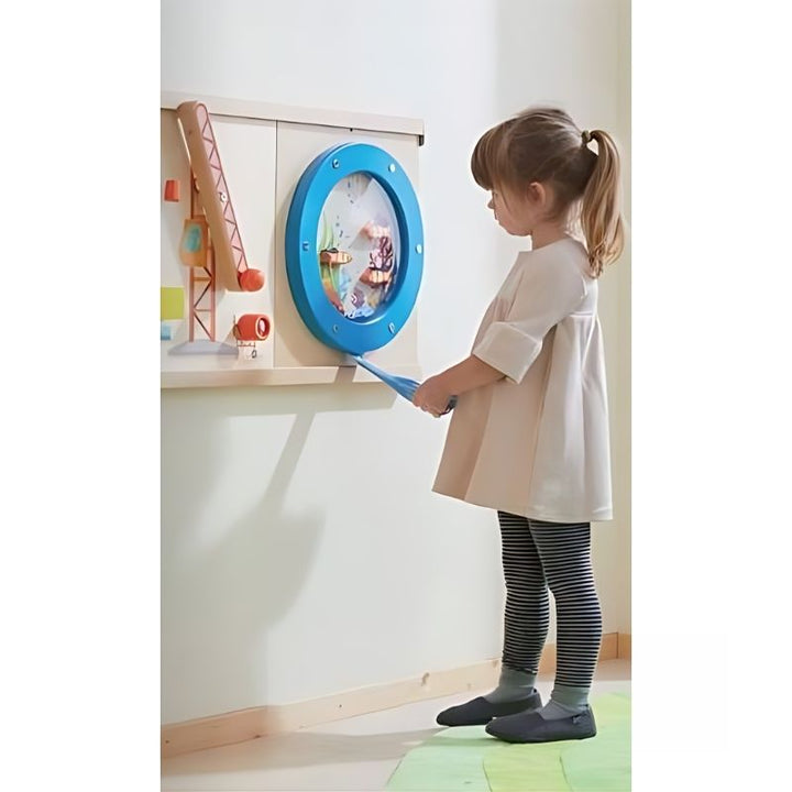 Young girl interacting with the HABA Pro Ocean Sensory Wall Panel, exploring the interactive activity wall panel in a home or therapy room setting
