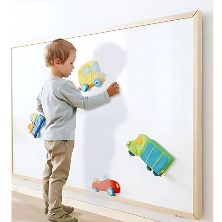 HABA Pro Whiteboard Wall Panel in use by a child, showing the magnetic dry-erase surface and birch wood frame in an active learning setting