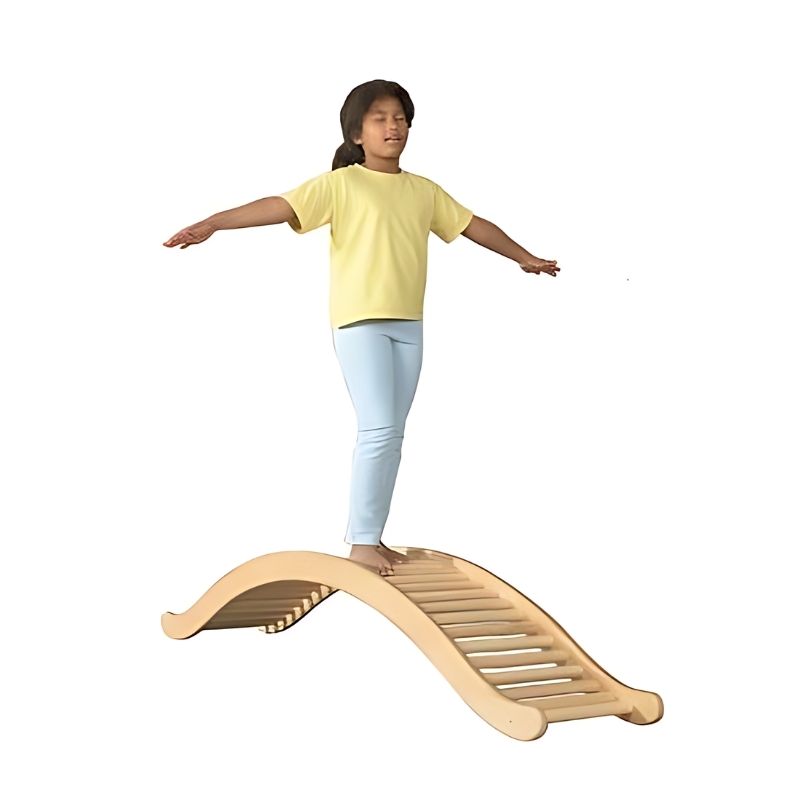 Child balancing eyes closed on the HABA Pro wooden seesaw rocker, engaging vestibular and proprioceptive systems during sensory play