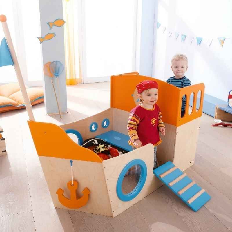 Children in imaginative pirate play on the HABA Play Sailboat, a wooden playhouse for daycares and homes