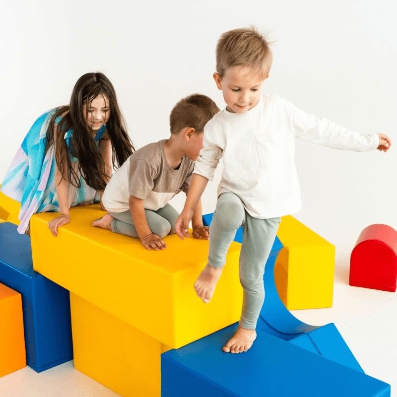Child exploring and building with the IGLU Mega Castle foam blocks, demonstrating imaginative play and sensory development
