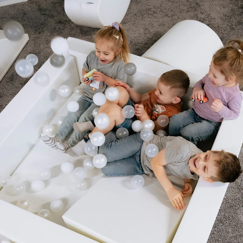 IGLU Soft Play Square Ball Pit shown from above with colourful balls raining into the foam pit, a sensory play ball pit for toddlers