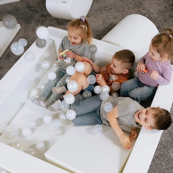IGLU Soft Play Square Ball Pit shown from above with colourful balls raining into the foam pit, a sensory play ball pit for toddlers