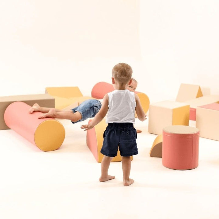Child viewed from behind climbing the IGLU Soft Play Fortress Set, showing the full block configuration and eco-leather surface detail