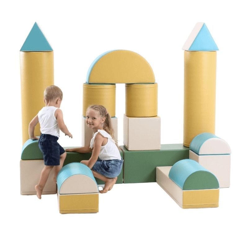 Two children playing with the IGLU Soft Play Fortress Set in pastel turquoise, climbing and building with foam blocks in a home playroom