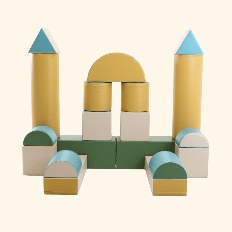 Clean product shot of the IGLU Soft Play Fortress Set in pastel turquoise, showing the full foam block arrangement, eco-leather cover, and castle structure