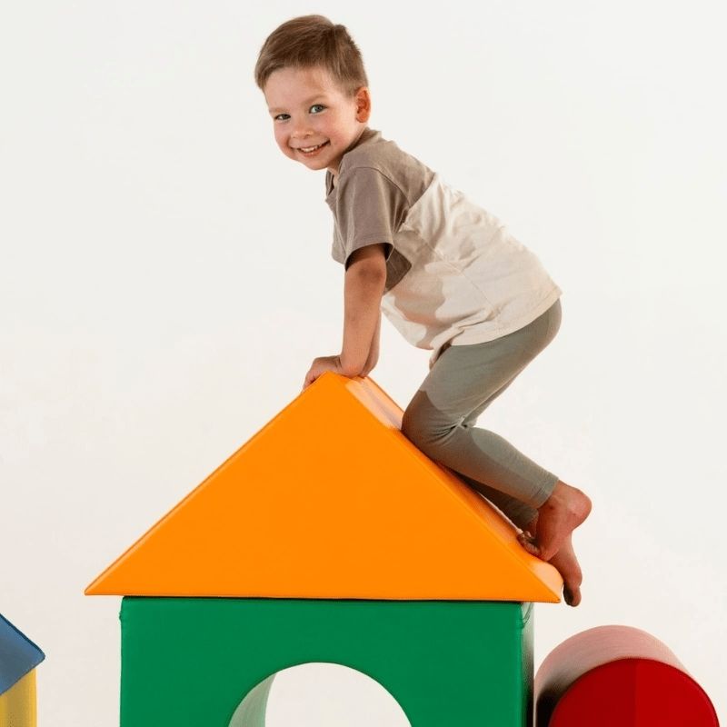 Children actively climbing and playing on the IGLU Soft Play Mega Castle Set, developing gross motor skills and spatial awareness