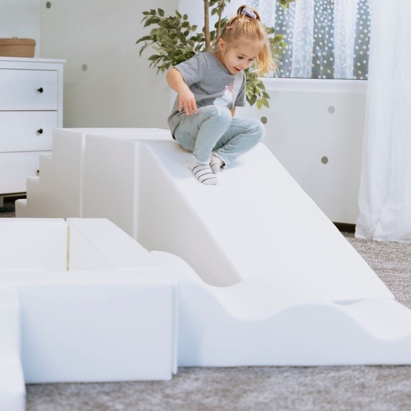 Girl climbing and sliding on the IGLU Step and Slide, part of the 8-piece IGLU Soft Play Party Set for ages 1 to 9