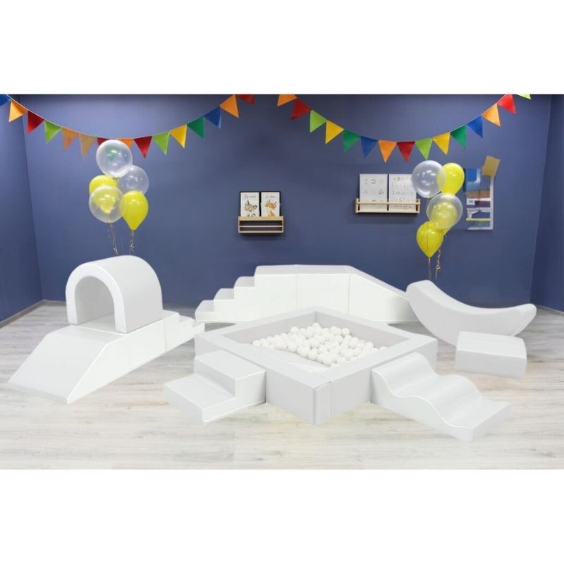 IGLU Soft Play Party Set in white, showing the complete foam play layout including ball pit, step and slide, and banana rocker