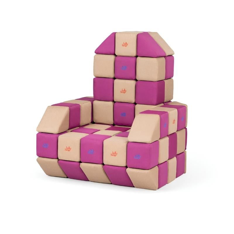 An armchair built from JollyHeap Basic Set magnetic foam blocks in tan and magenta, showing how this soft play block set can be arranged into seating.