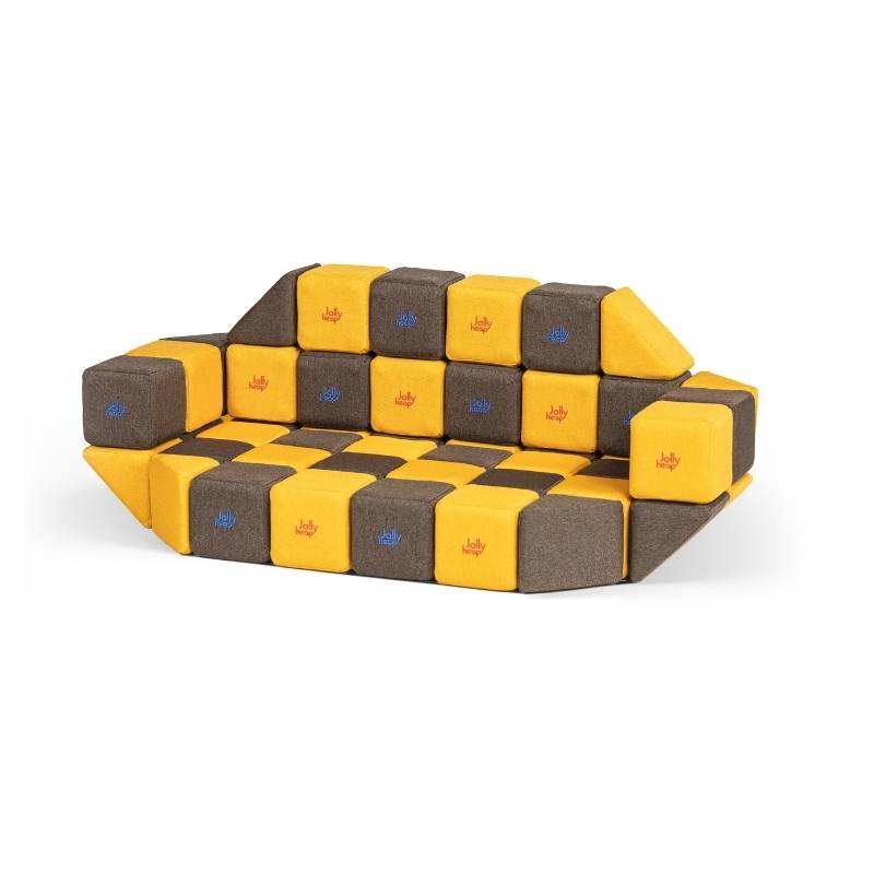 A couch built from JollyHeap Medium Set magnetic soft blocks in a checkerboard pattern, demonstrating furniture-scale building