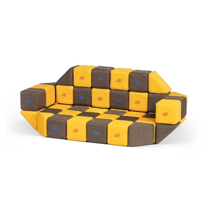 A couch built from JollyHeap Medium Set magnetic soft blocks in a checkerboard pattern, demonstrating furniture-scale building
