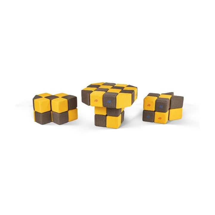 Three small separate constructions built from JollyHeap magnetic soft blocks, including a table-like form