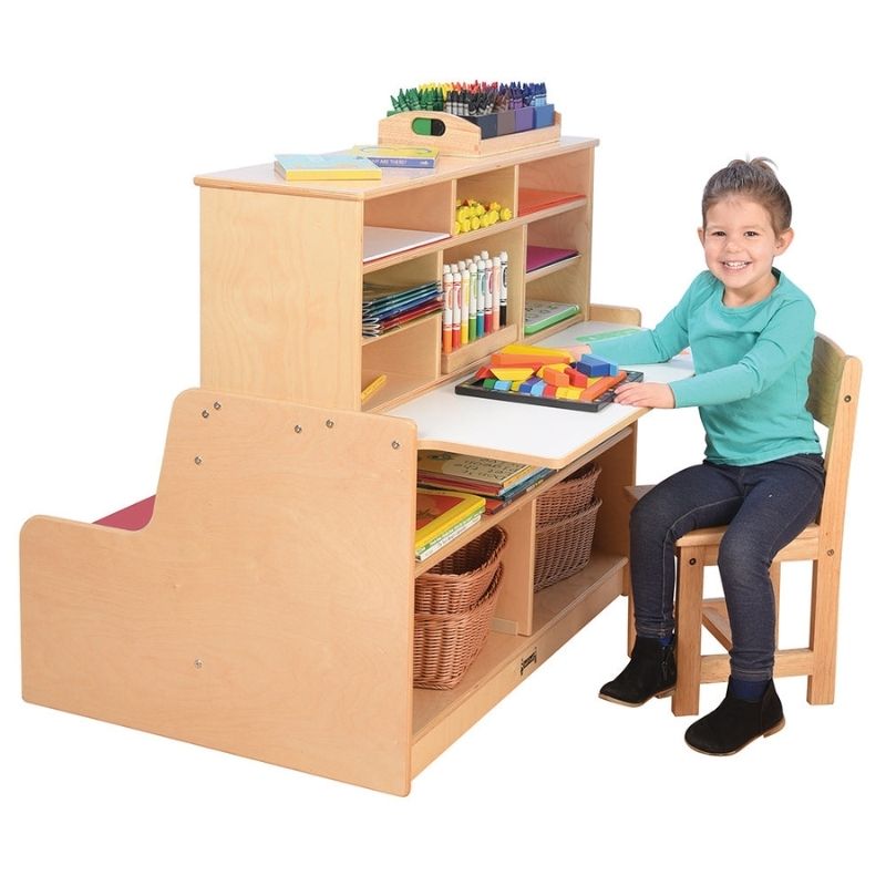 Child actively playing at the Jonti-Craft Literacy Station showing the cushioned reading bench, writing desktop, and integrated storage of this classroom literacy centre