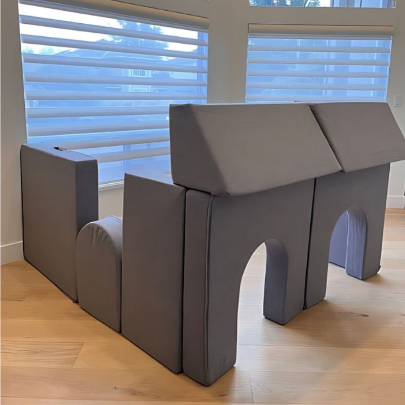 KiiCo Couch MAX assembled into a house structure indoors, demonstrating the modular fort-building and imaginative play possibilities of the 10-piece play couch set