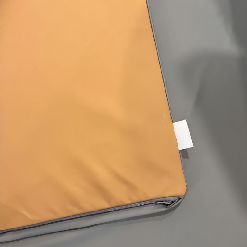 KiiCoPlay Bliss Playmat close-up view showing the dual-sided vegan leather cover texture and OEKO-TEX certified natural latex foam construction detail