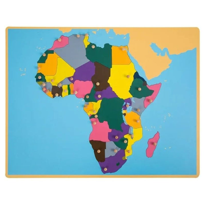 Kinderhuis Montessori geography cabinet showing the Africa puzzle map with laser-cut country pieces and capital knobs