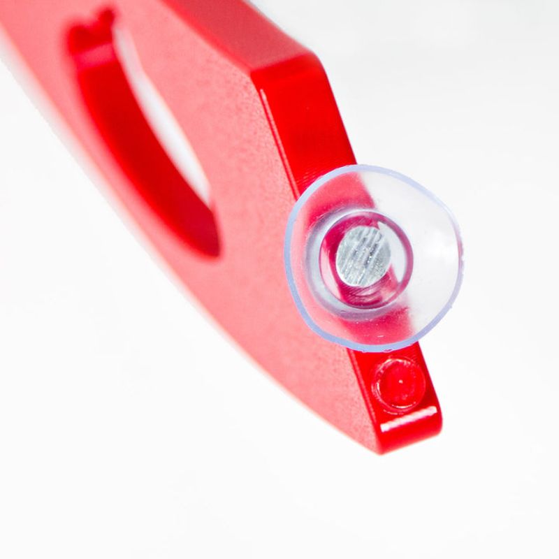 Close-up of Kinnebar K100 Foot Swing in red showing suction cups and base attachment system for secure desk installation