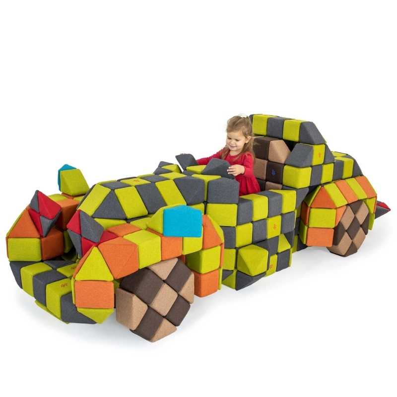 Child playing inside a race car structure built from the JollyHeap large magnetic foam block set