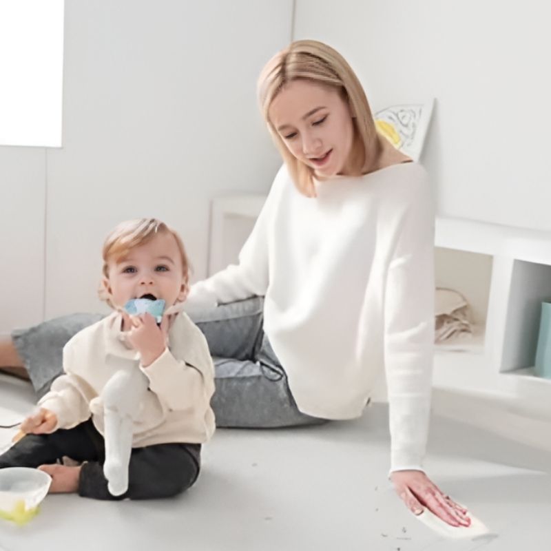 Close-up of mom and child on the Licoco Clean Roll Playmat Plus Gray, showing the smooth PU anti-bacterial surface and cushioned 4cm foam construction of the Korean baby play mat