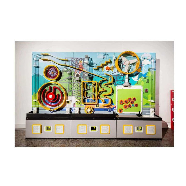 LiteZilla Ultimate Ball Launcher 12x8 commercial installation showing the full width of the air-powered exhibit with large circular gear elements, conveyor pathways, and an energy-themed customizable mural backdrop