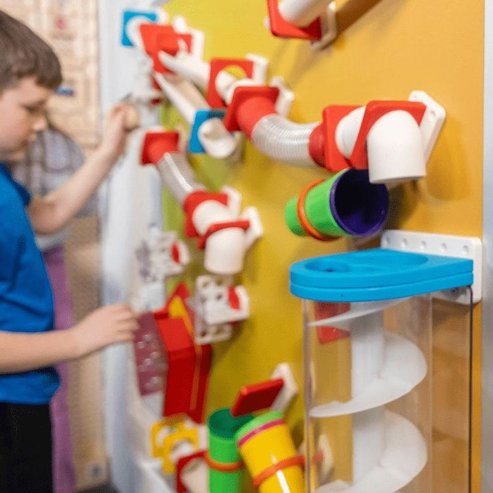 Child engaging with the LiteZilla MagWiz Magnet Wall, a hands-on STEM sensory wall for schools and therapy spaces