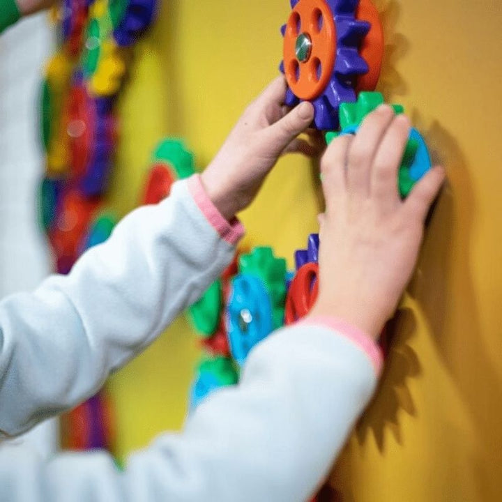 Multiple users interacting with the LiteZilla MagWiz interactive magnetic sensory wall, supporting collaborative STEM play