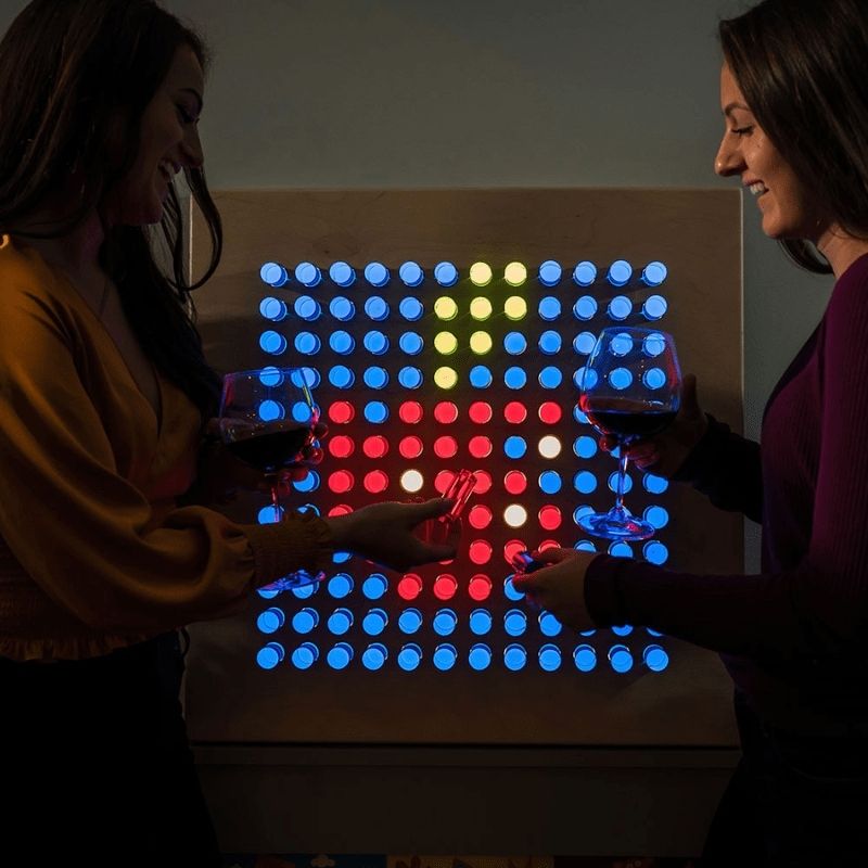 Two adults creating a design on the LiteZilla Mini LED light board during a collaborative session