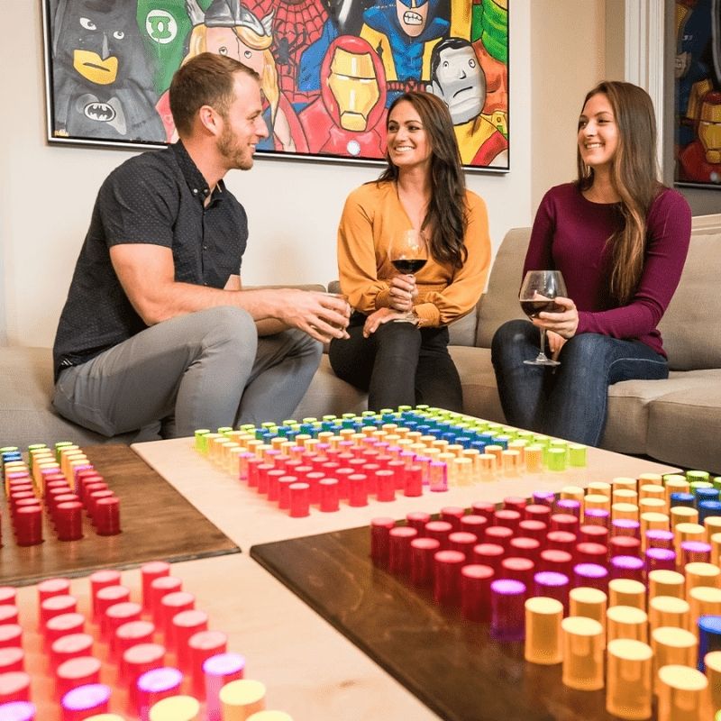 Three adults collaborating around the LiteZilla Mini sensory light board, highlighting its use in social and therapeutic settings