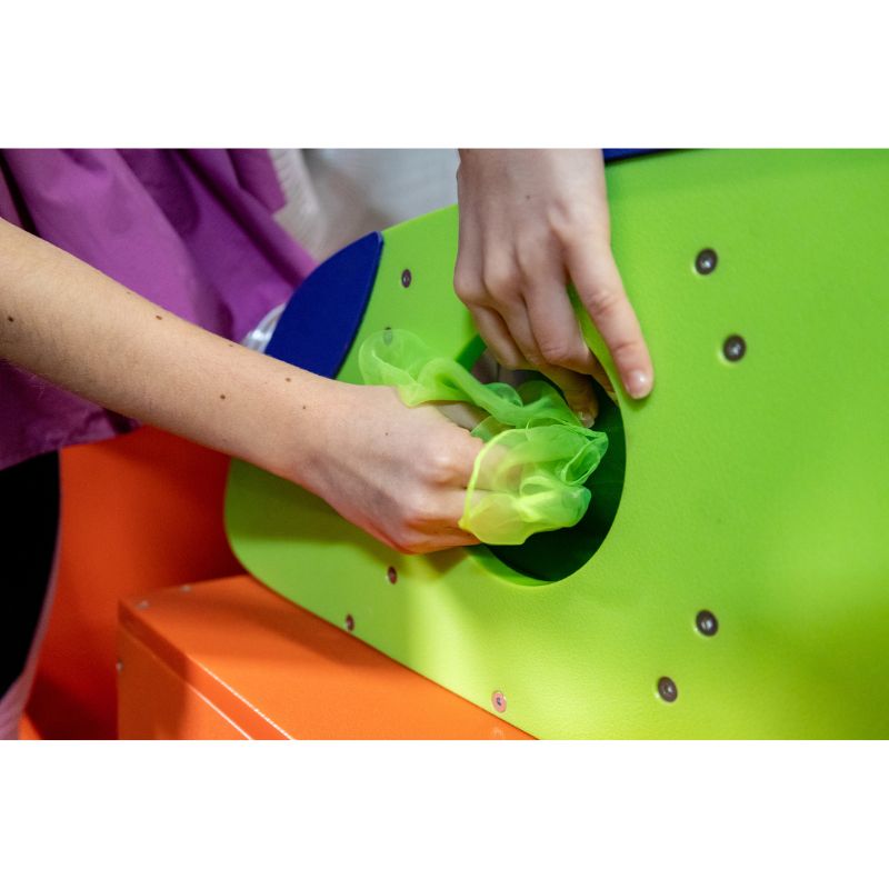 Child inserting a scarf into the LiteZilla Ultimate Scarf Launcher inlet to demonstrate air-powered pneumatic tube sensory play