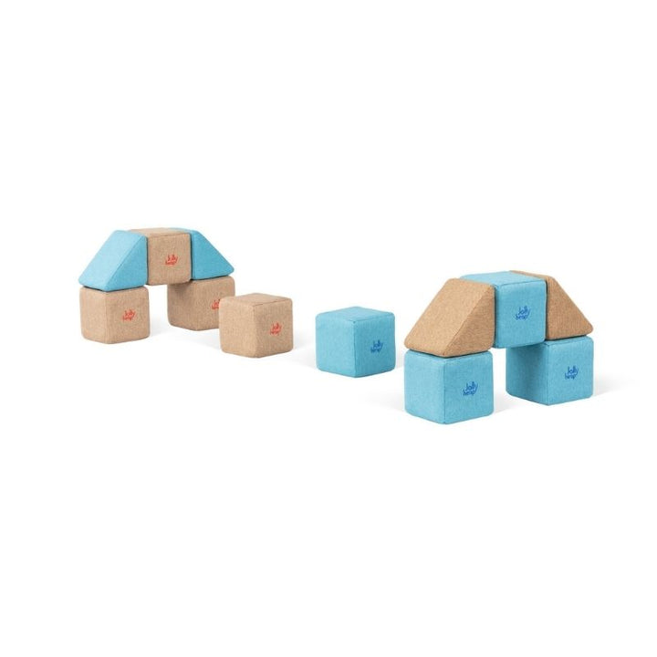 Two small arch shaped structures built from JollyHeap Pixi magnetic building blocks with loose cubes alongside
