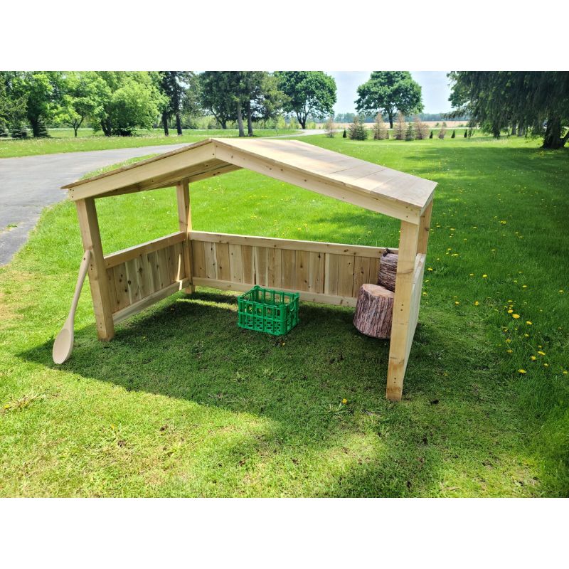 Side view of the ONP Outdoor Group Play Cabana showing the Western Red Cedar frame, short wind shelter walls, and open-front access, a permanent outdoor classroom shade structure for preschool and early years settings