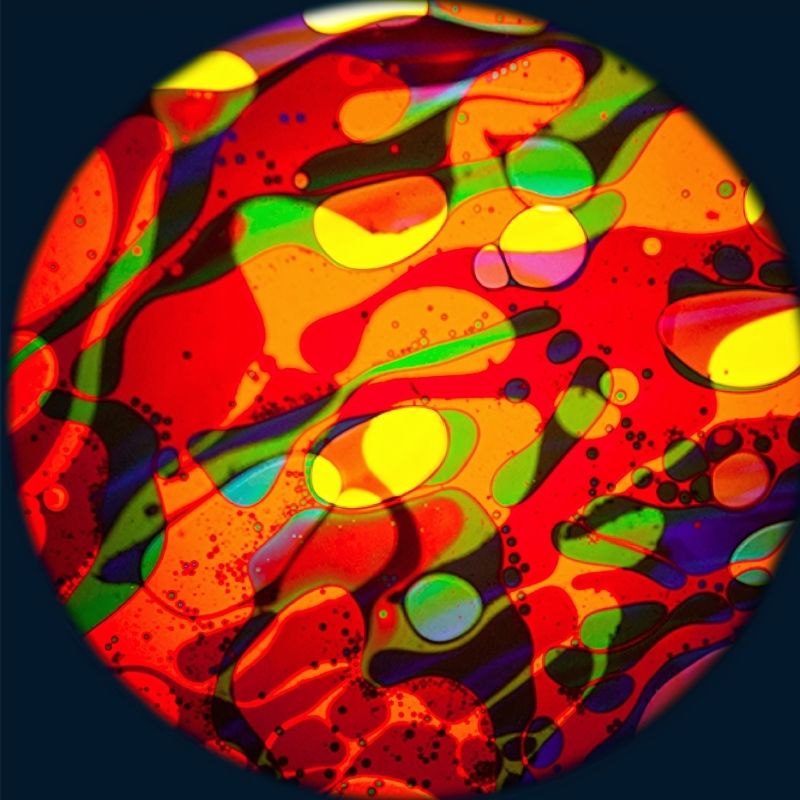OPTIKinetics 6 inch Liquid Effect Wheel Cosmic Flare showing the multi-colour oil projection pattern with vibrant yellows, greens, and blues for sensory room projectors
