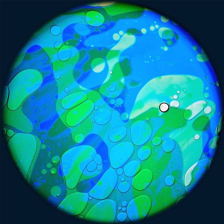 OPTIKinetics 6 inch Liquid Effect Wheel Ocean Breeze showing the cool-toned oil-based lava lamp projection effect for calming sensory rooms and therapeutic spaces