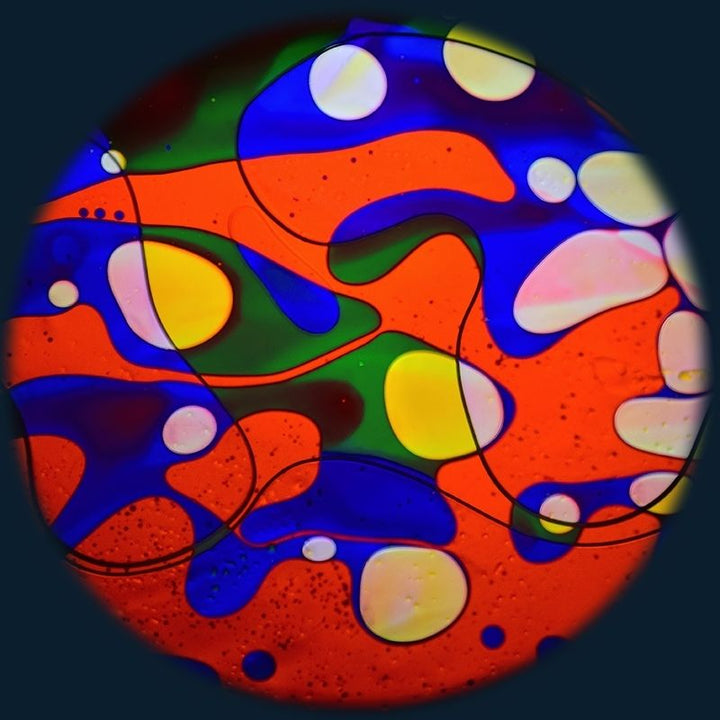 OPTIKinetics 6 inch Liquid Effect Wheel Rainbow Dream displaying its multi-colour oil projection for calming visual sensory environments in therapy rooms and classrooms