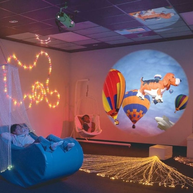 OPTIKinetics Solar 100 LED projector displaying a dog and balloons picture effect wheel projection, showing the clarity and colour of the 85mm lens output