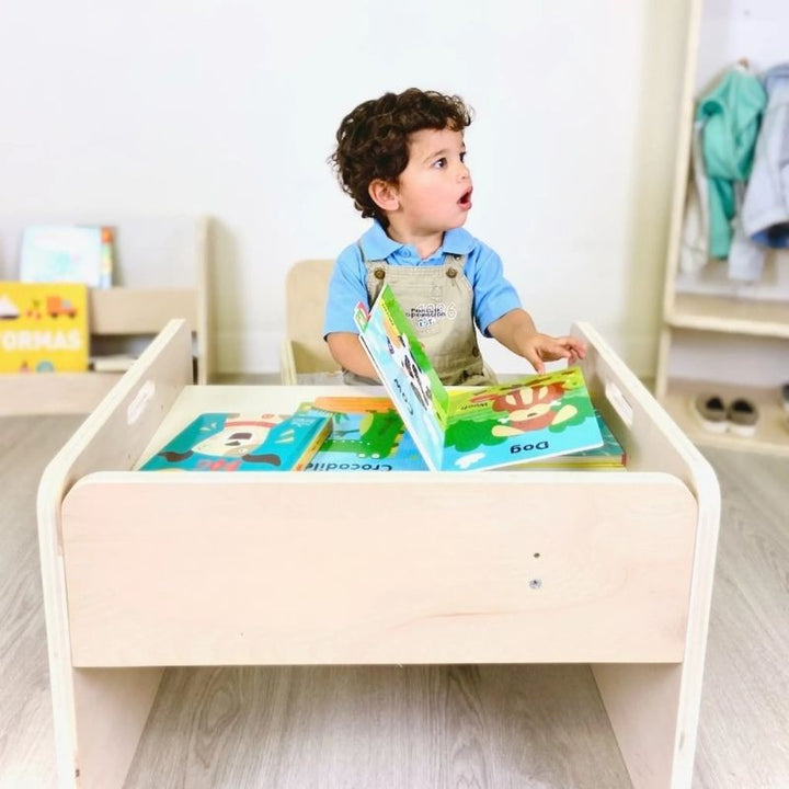Boy child viewed from the front actively using the Sapiens Child Papaya Set Montessori table and chair, showing the correctly sized workspace for independent mealtime and Montessori activity