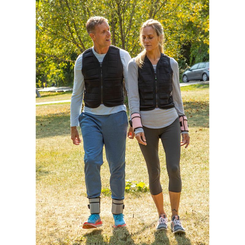 Adult couple wearing Power WearHouse weighted vests outdoors, showing the deep pressure vest in casual everyday use