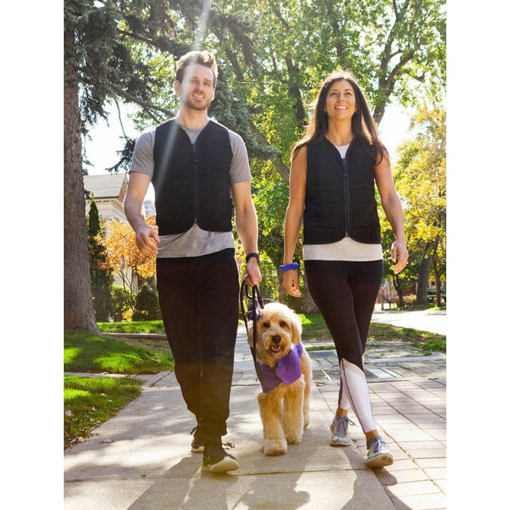 Power WearHouse weighted vest for adults worn by a couple outdoors, showing the slim neoprene design suitable for everyday wear