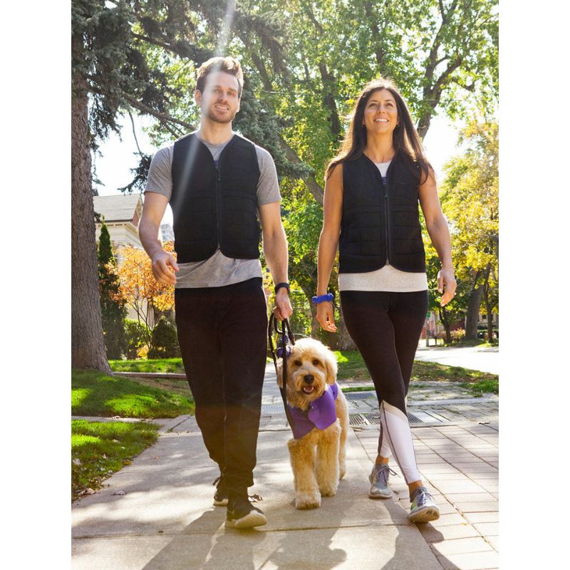 Power WearHouse weighted vest for adults worn by a couple outdoors, showing the slim neoprene design suitable for everyday wear