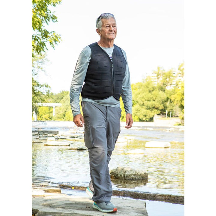 Adult male wearing the Power WearHouse deep pressure weighted vest by a lake, showing calming sensory regulation in daily life