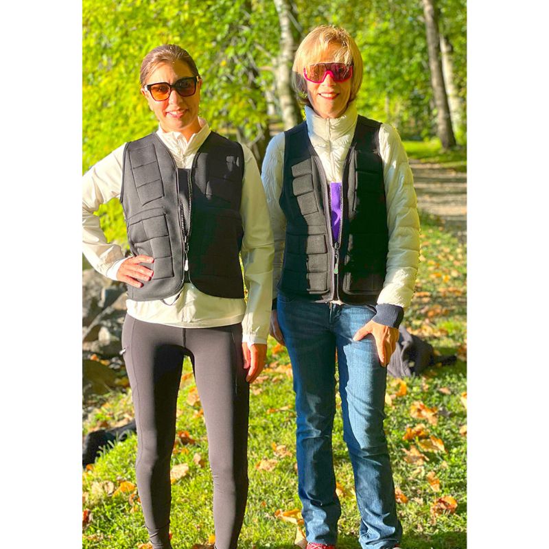 Two adult women wearing Power WearHouse weighted vests, demonstrating the slim fit and inclusive sizing range