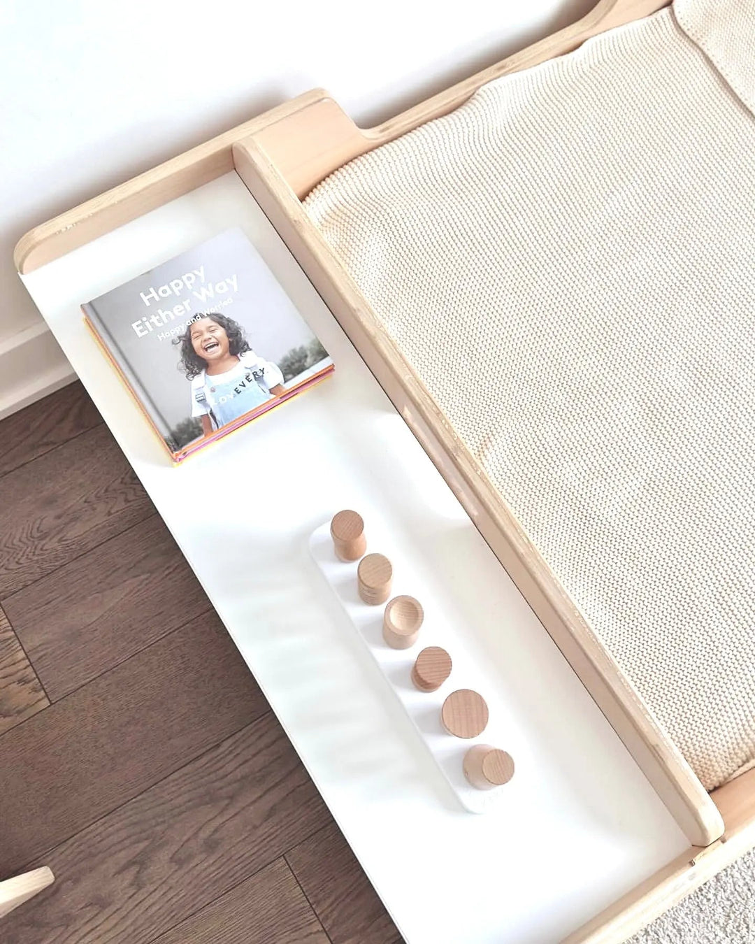 Sapiens Child Apple Montessori floor bed with rails styled in a toddler bedroom, showing the compact Canadian-made design in a real home setting