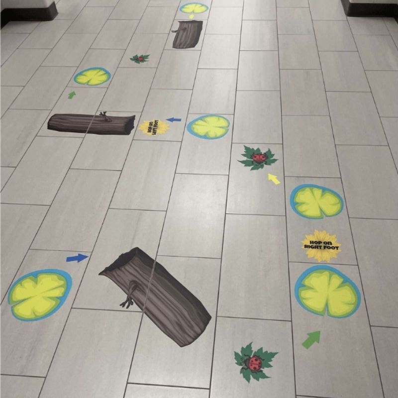 Sensory Paths Nature Walk Full Path installed in a school hallway showing the complete outdoor nature sensory movement corridor with frogs, lily pads, logs and 3M vinyl anti-skid floor decals