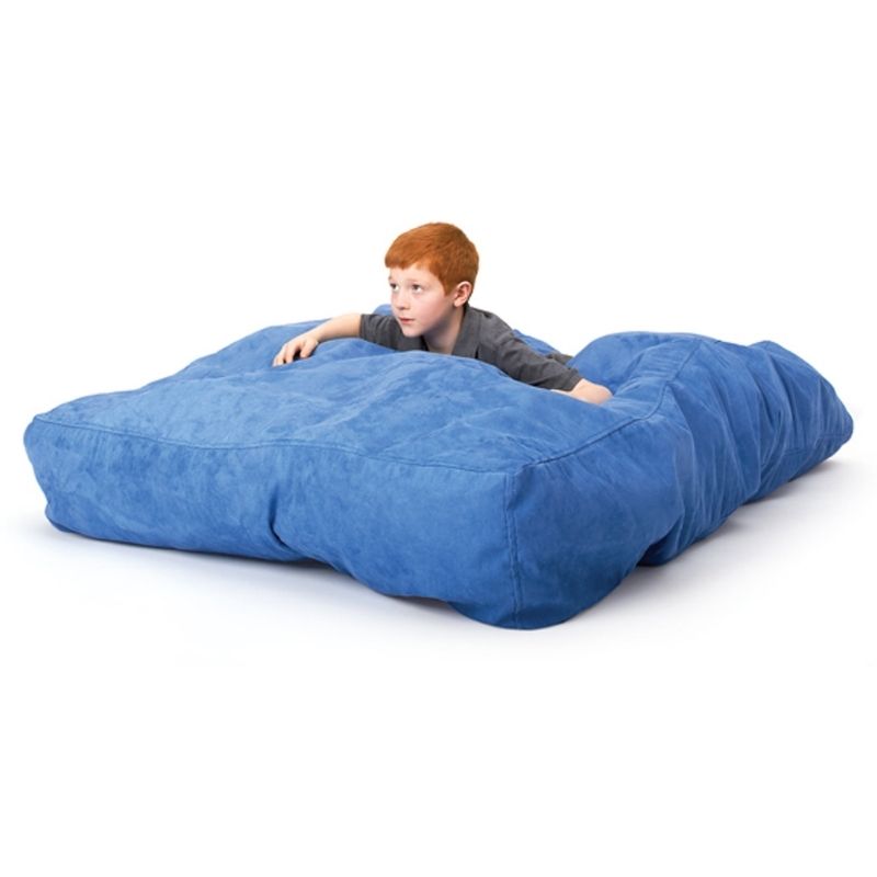 Child jumping onto the Southpaw Cloud Nine Crash Mat during active sensory play, demonstrating the mat's safe impact absorption for proprioceptive input