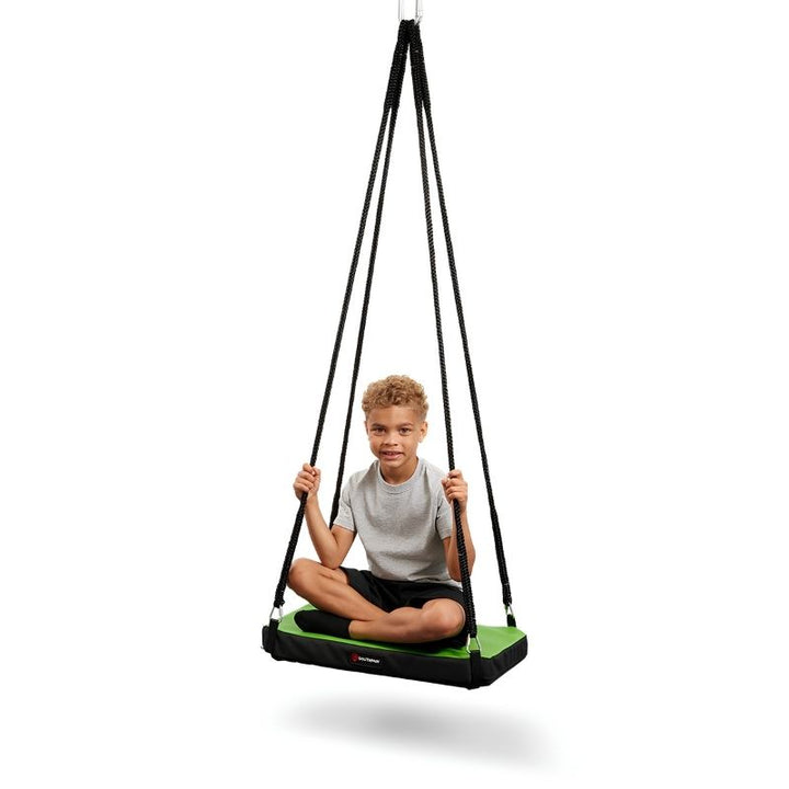 Boy seated on the Southpaw Soft-Lite Junior Glider sensory platform swing, demonstrating comfortable single-user positioning for paediatric OT sessions